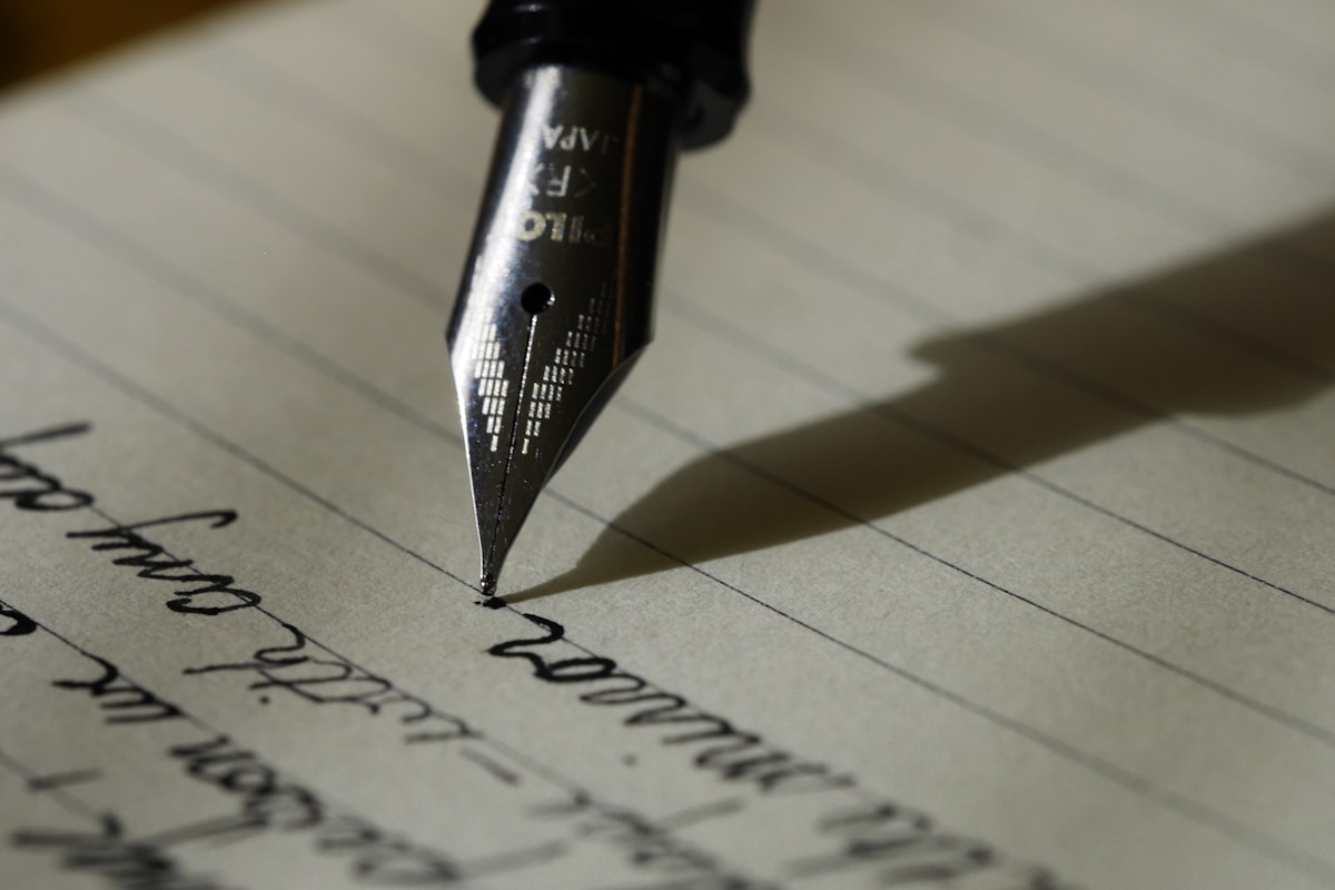 A fountain pen resting on a document, symbolizing the importance of written records in trust administration